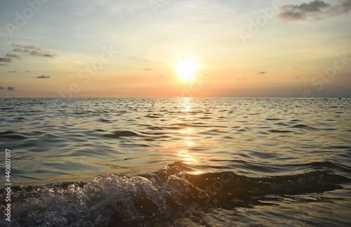 Orange sunset at sea  bright highlights on the waves