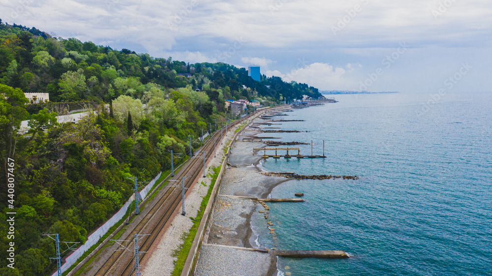 The road along the seashore. Russian resort town of Sochi. Aerial photography of the beach. Railroad along the seashore.