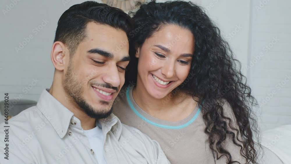 Smiling happy family married couple spaniard spouses boyfriend and girlfriend handsome hispanic man and curly woman cuddling sitting together indoors smile toothy dental read book letter message news Smiling happy family married couple spaniard spouses boyfriend and girlfriend handsome hispanic man and curly woman cuddling sitting together indoors smile toothy dental read book letter message news