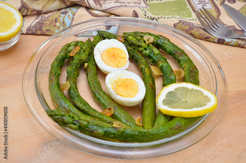 delicious and healthy lunch fried asparagus with boiled egg on a plate