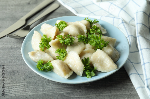 Concept of tasty food with vareniki or pierogi on gray textured table