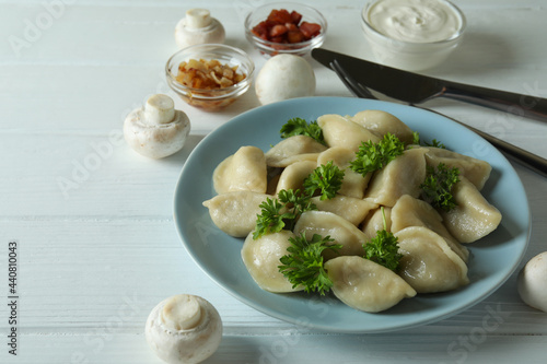 Concept of tasty food with vareniki or pierogi on wooden table