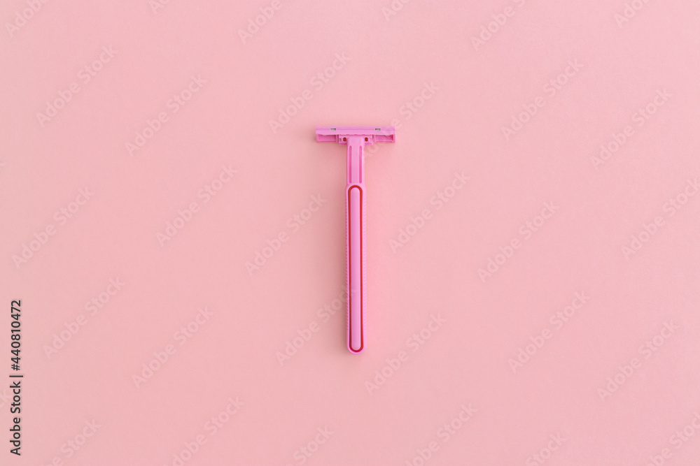 Woman pink plastic razor on pink background. Top view with copy space. Flat lay composition. Woman pink plastic razor on pink background. Top view with copy space. Flat lay composition.