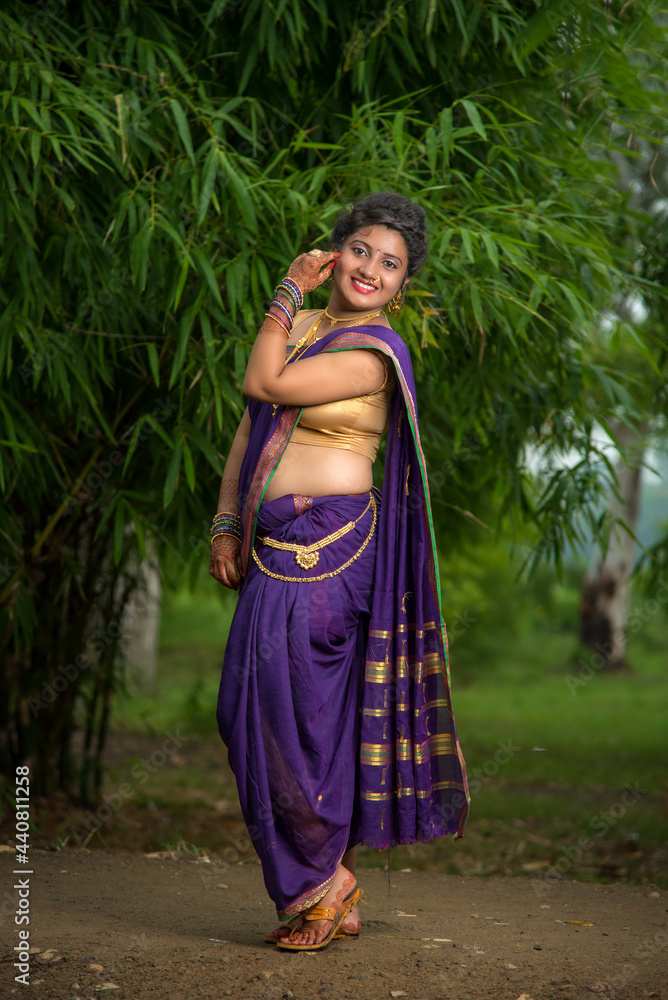 Indian Beautiful young girl in Traditional Saree posing outdoors