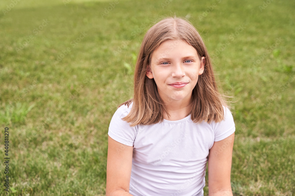Little girl portrait. Outdoor green background. Looking. Teenager schoolgirl at park. Cute face. Children beauty. Female head. Charisma caucasian Little girl portrait. Outdoor green background. Looking. Teenager schoolgirl at park. Cute face. Children beauty. Female head. Charisma caucasian