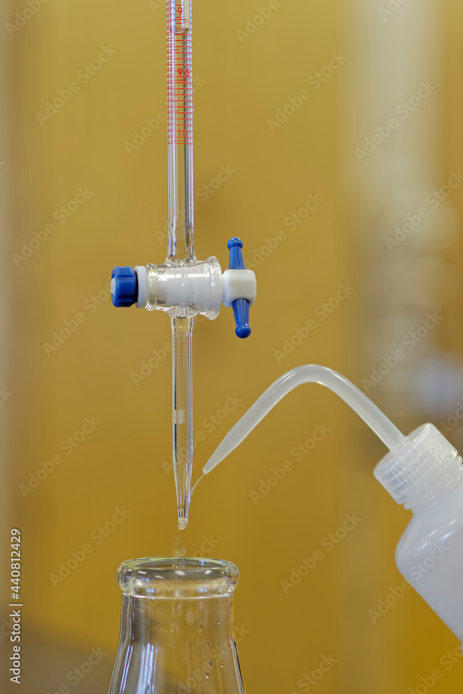 Washing the tip of a burette used for titrations in education and