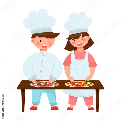 Two happy kids making pizza. Cute smiling boy and girl cooking together. Children with white chief hats. Cartoon style vector illustration, isolated on white.

