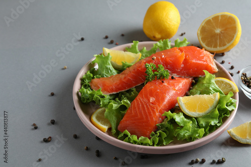 Concept of cooking salmon on gray background