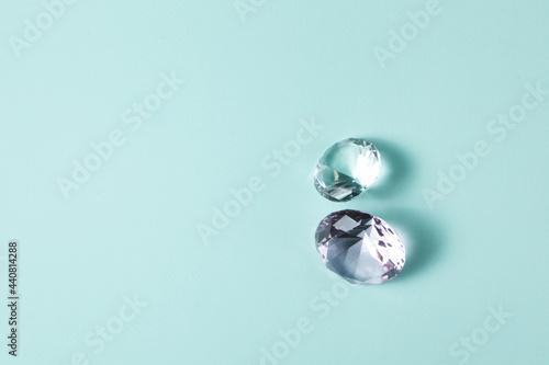 Precious gemstones for design gems jewellery. Diamonds crystal on turquoise background.