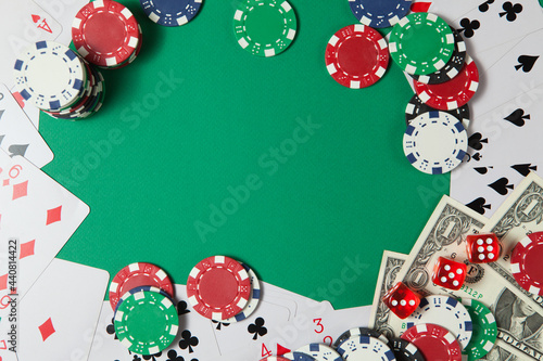 Classic playing cards, chips, red dice and dollars on green background. Gambling and casino concept.