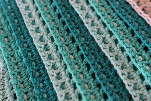 Photography Closeup shot of a blue green crocheted fabric
