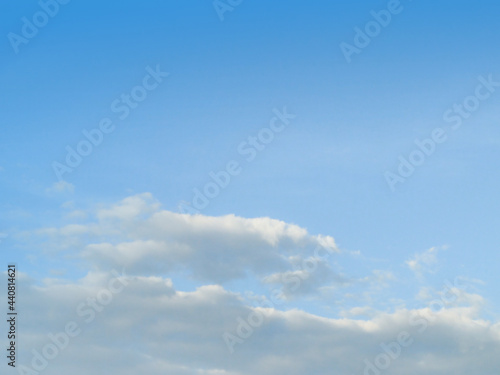 White fluffy clouds in the blue sky background. The image in clearing day and good weather on morning of the summer season.