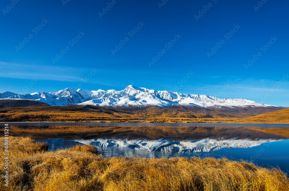 Mountains of the North-Chui range and their reflection in the lake Dzhangyskol, Yeshtykel tract, fall.  Altai Republic, Russia