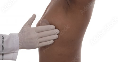 Side view of a mammologist doctor is checking woman breast. Isolated, white background. Healthcare concept.