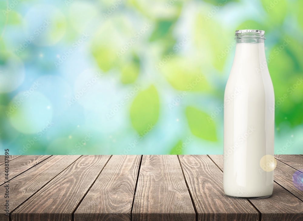Glass bottle of white milk on the desk Glass bottle of white milk on the desk