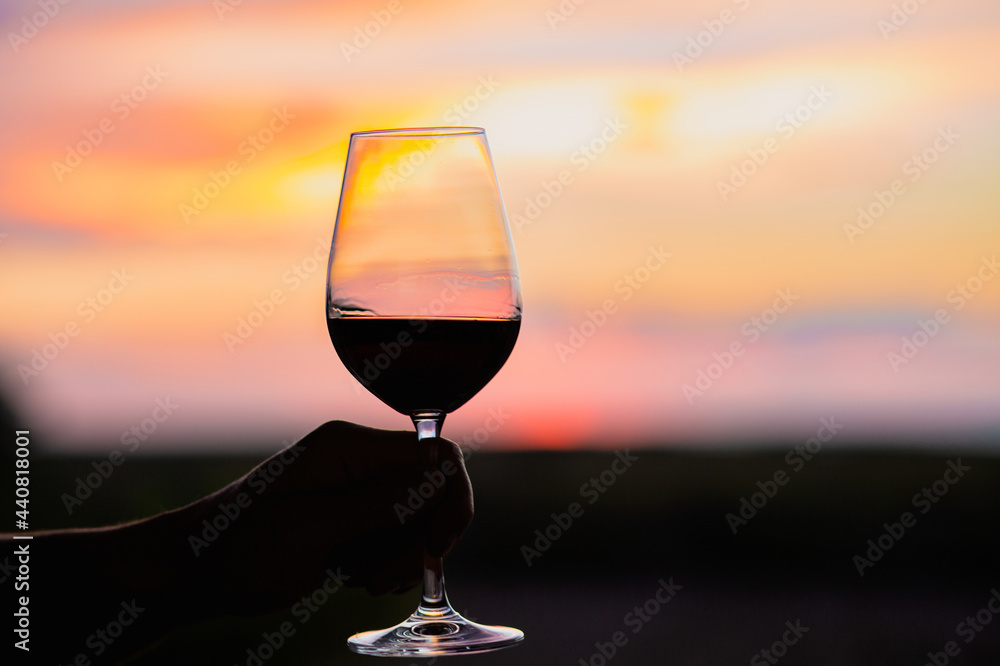 Sunset with a glass of wine.Beautiful sky with sunset with a glass of wine.A glass of wine at sunset in the mountains.Red wine. Relax.Summer concept.Summer with sunset.August. Summer vacation 
