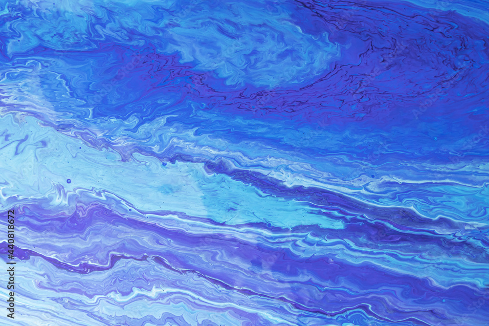 Fototapeta premium Blue-purple waves of paint. Abstract background with marble effect