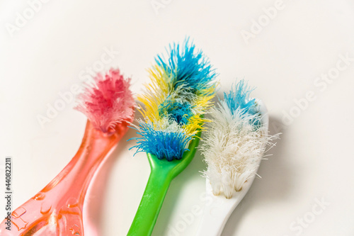 Old  spoiled  disheveled  colored toothbrushes renewal  replacement