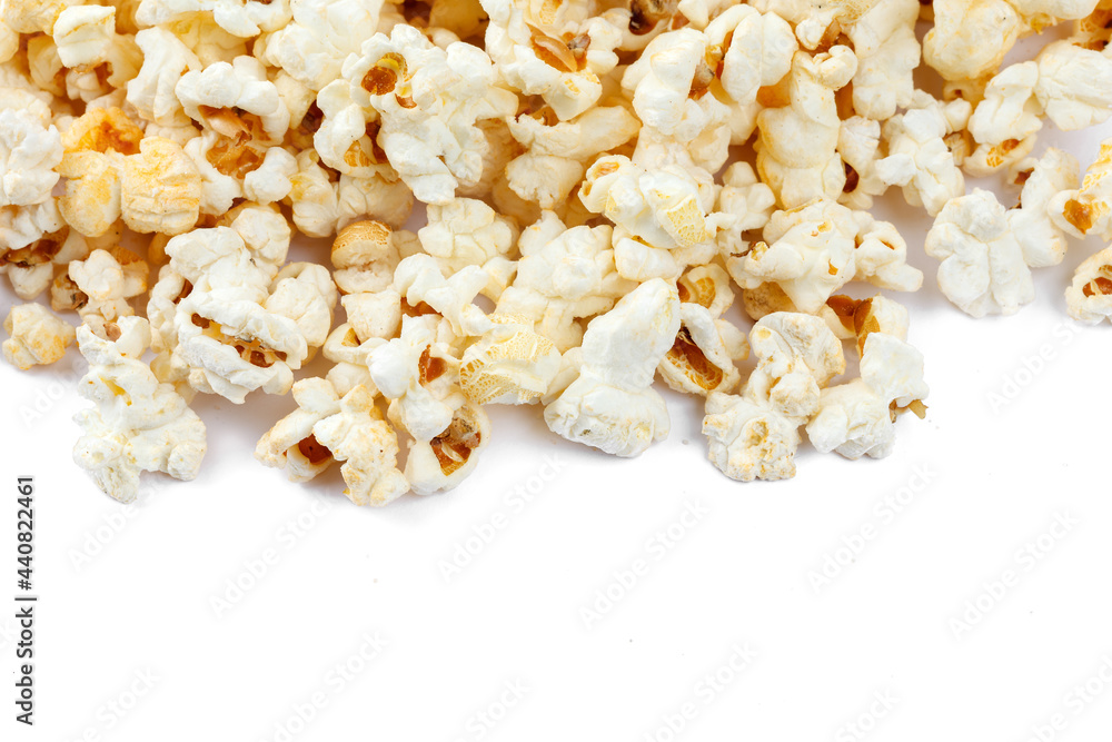 Heap of delicious popcorn, isolated on white background. Scattered popcorn texture background. Close-up.