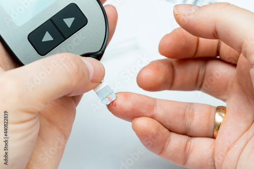 Taking blood from finger for sugar level medical test