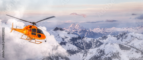 Yellow Helicopter flying over the Rocky Mountains during a sunny sunset. Aerial Landscape from British Columbia, Canada near Vancouver. Adventure Composite. Art Render