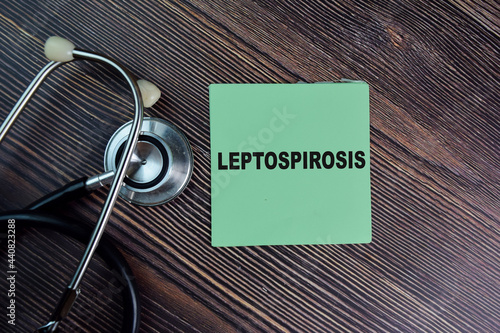 Leptospirosis write on sticky notes isolated on Wooden Table. medical concept