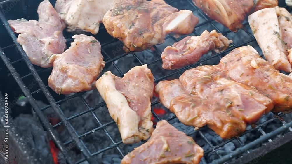 Close up on process cooking roasted pork beef with marinade onion sauce on BBQ grill. Process of Cooking pork meat on grill. Food cooked on grilling barbecue in house backyard. eating dinner outdoor Close up on process cooking roasted pork beef with marinade onion sauce on BBQ grill. Process of Cooking pork meat on grill. Food cooked on grilling barbecue in house backyard. eating dinner outdoor