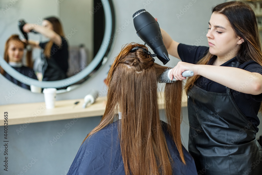 barber dries his hair., cuts her hair to a girl with long hair. a woman dyes her hair, dries her hair with a hair dryer barber dries his hair., cuts her hair to a girl with long hair. a woman dyes her hair, dries her hair with a hair dryer