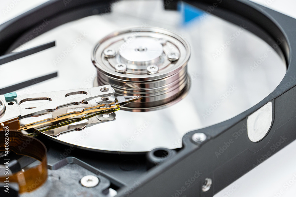 Open hard disk drive close up. Information, cloud data storage, infrastructure cost concept Open hard disk drive close up. Information, cloud data storage, infrastructure cost concept
