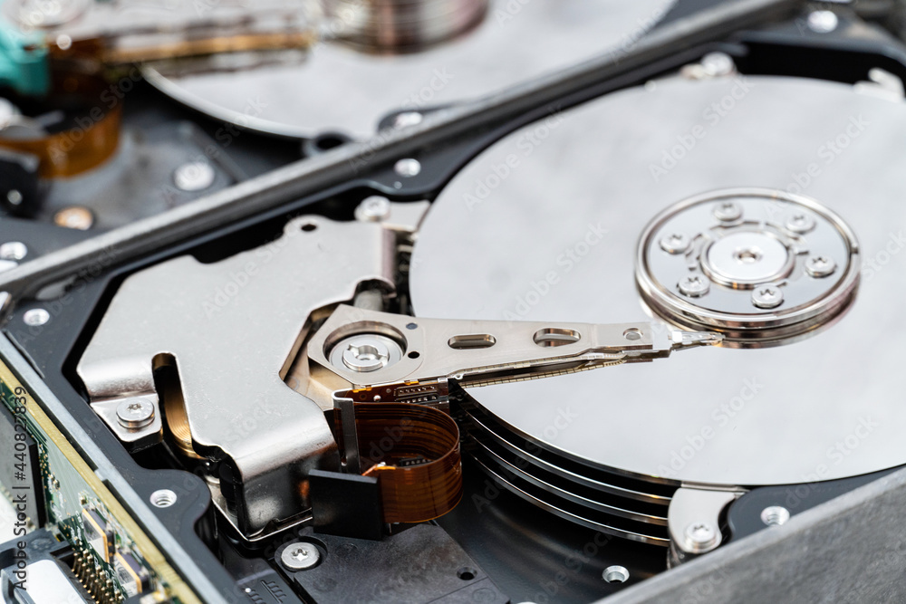 Open hard disk drive close up. Information, cloud data storage, infrastructure cost concept Open hard disk drive close up. Information, cloud data storage, infrastructure cost concept