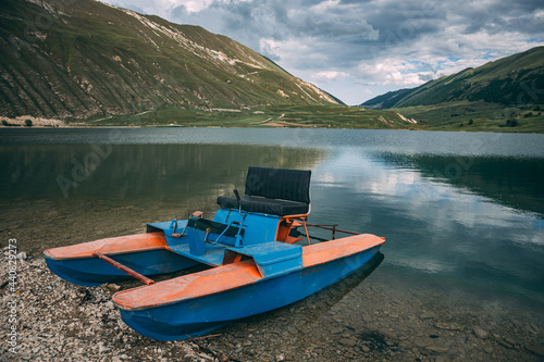 catamaran stands on the shore of the lake