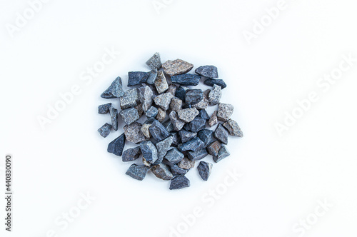 A pile of small rubble close-up on white background. View from above.