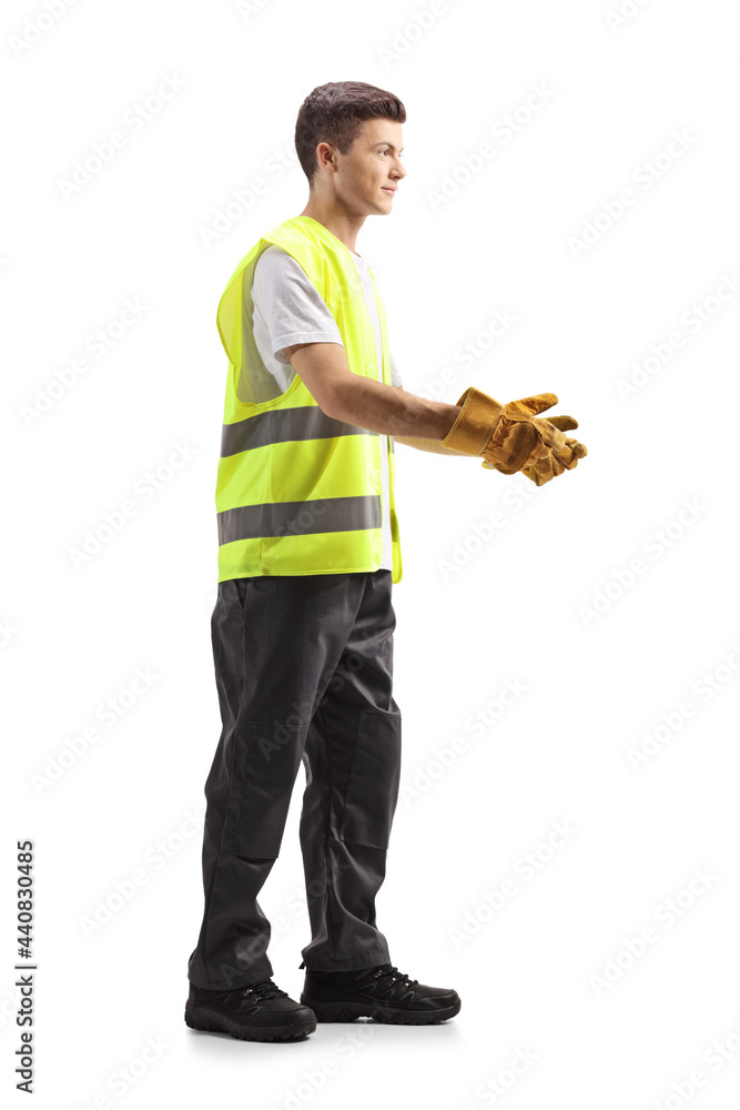 Full length profile shot of a young waste collector in a uniform and gloves gesturing with hands Full length profile shot of a young waste collector in a uniform and gloves gesturing with hands