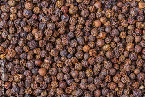 Large pile of allspice peas. Food background.Background made of middle eastern traditional spice . Top view.Textures of colorful spices and condiments.
