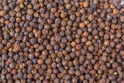 Large pile of allspice peas. Food background.Background made of middle eastern traditional spice . Top view.Textures of colorful spices and condiments.