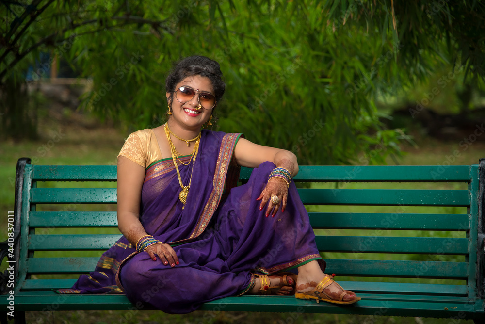 Beautiful Indian young girl in Traditional Saree posing outdoors Beautiful Indian young girl in Traditional Saree posing outdoors