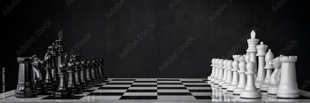 Chess pieces are arranged on a chessboard. The beginning of a chess game. Chess as a symbol of leadership, struggle, victory, strategy, business. Retro style.