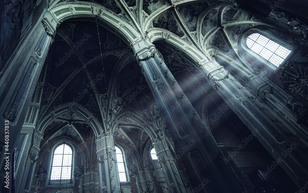 Mysterious rays of light in an old Gothic church. Inside a Christian temple. Concept on the theme of religion, faith, mysticism and history.