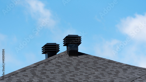 Ventilation covers on a new house shingle roof photo