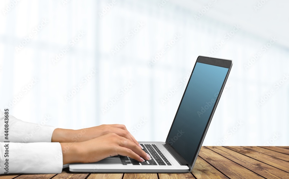 The hands of a business person are typing on a laptop keyboard. The concept for the workplace. The hands of a business person are typing on a laptop keyboard. The concept for the workplace.