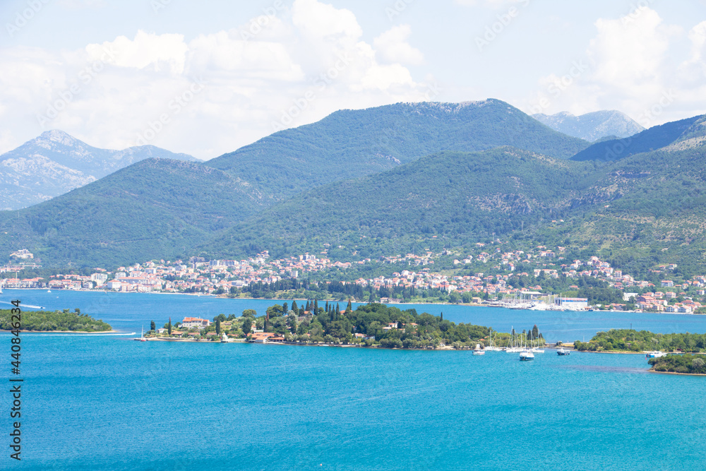 View of the city of Tivat, which is located in Montenegro on the Adriatic Sea. You can see the blue sea, islands and mountains.