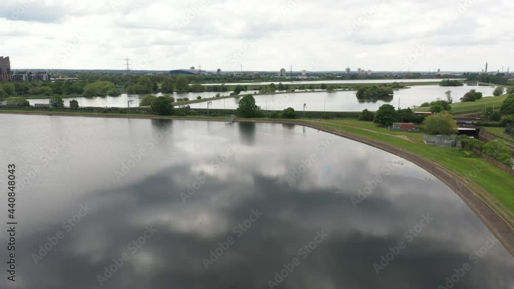 flight over water reservoir system towards dyke with railway track and road flight over water reservoir system towards dyke with railway track and road