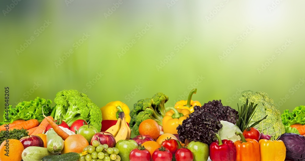 Panorama fruits, vegetables, berries on green blurred background Panorama fruits, vegetables, berries on green blurred background