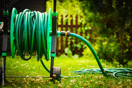 Garden hose for watering plants in garden photo