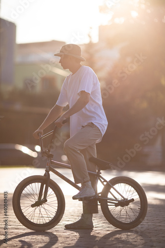 Fototapeta Naklejka Na Ścianę i Meble -  Young guy on a bicycle in the sunset.