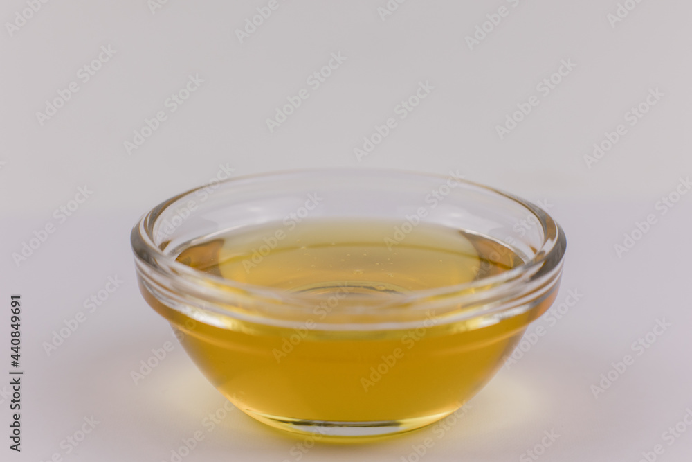 glass bowl with fresh golden liquid honey
