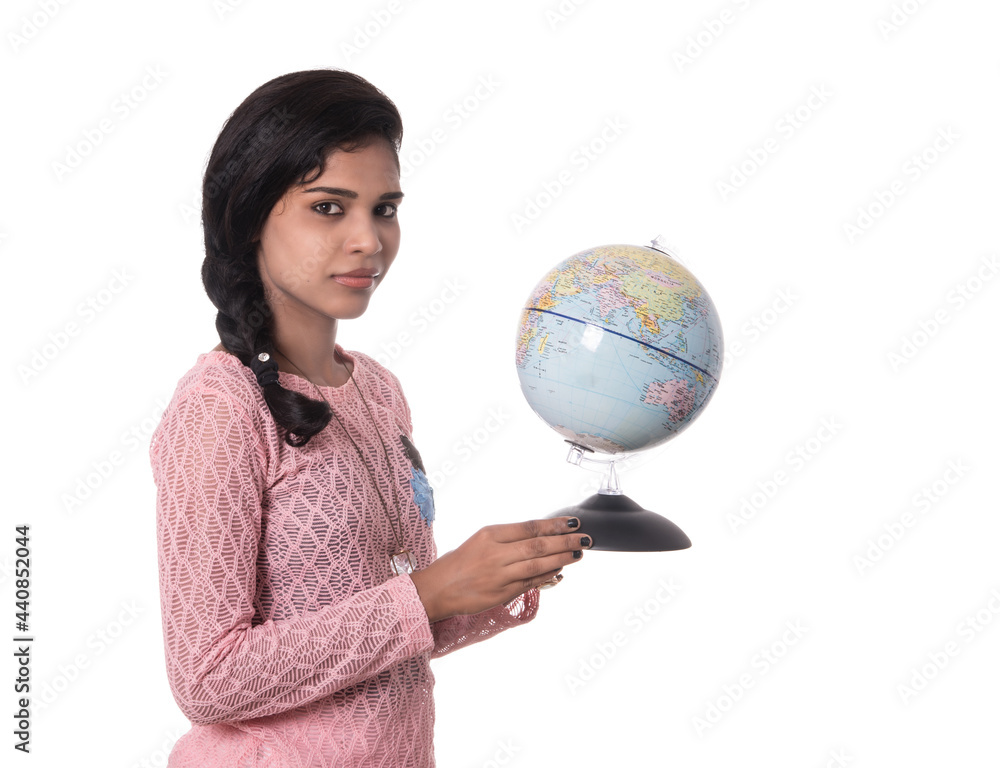 Beautiful Girl holding a world globe isolated on a white background Beautiful Girl holding a world globe isolated on a white background