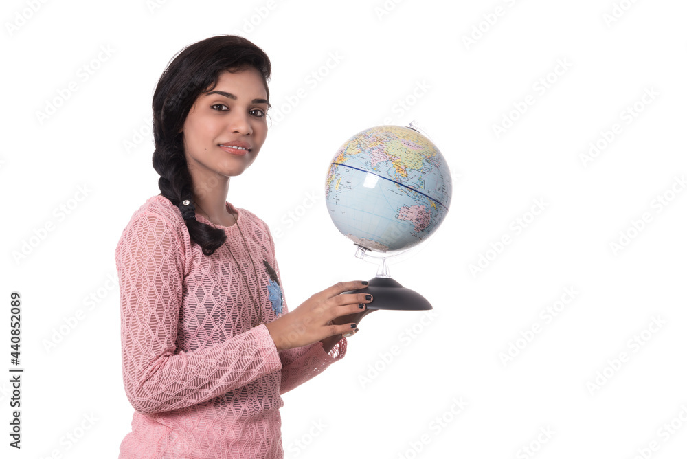 Beautiful Girl holding a world globe isolated on a white background Beautiful Girl holding a world globe isolated on a white background