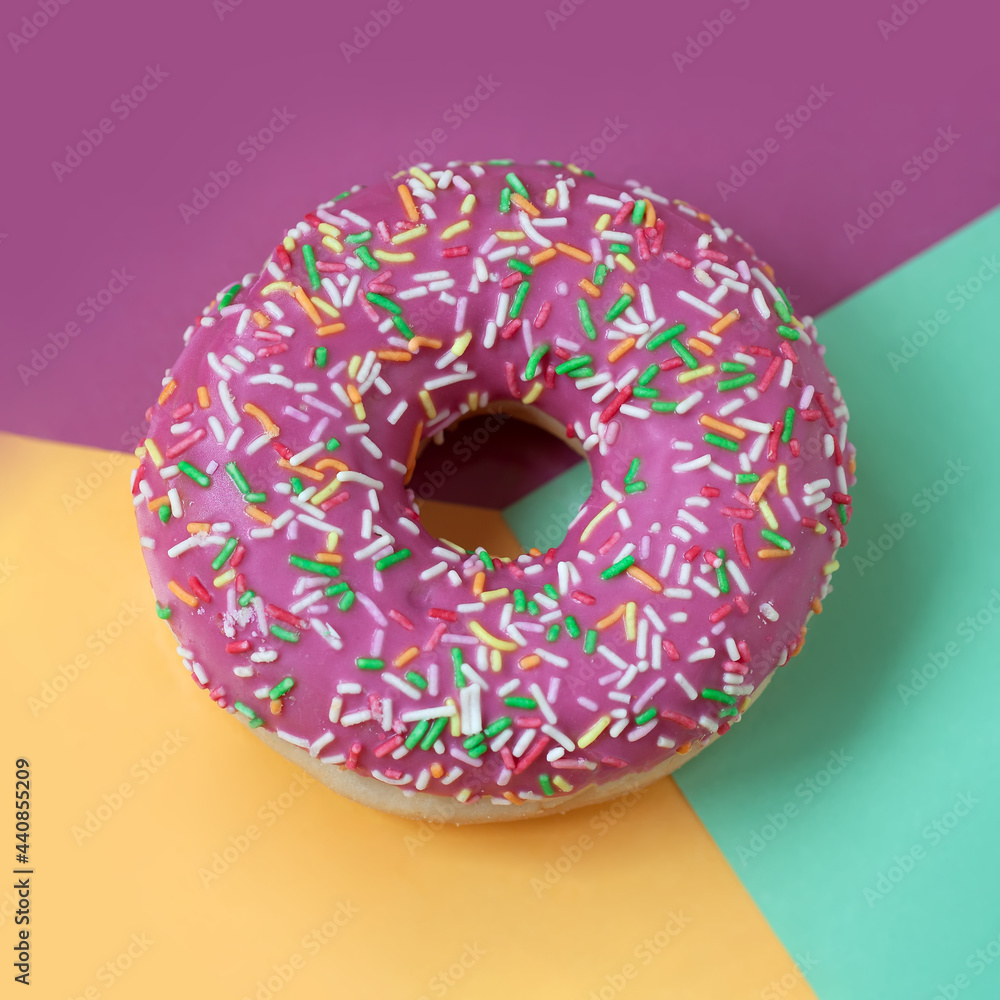 Pink Sweet donut with icing on coloful background close-up, top view. Pink Sweet donut with icing on coloful background close-up, top view.