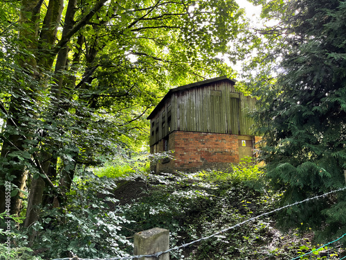 Old building, hidden by old trees, next to a country trail near, Tweedy Lane, Wilsden, UK photo